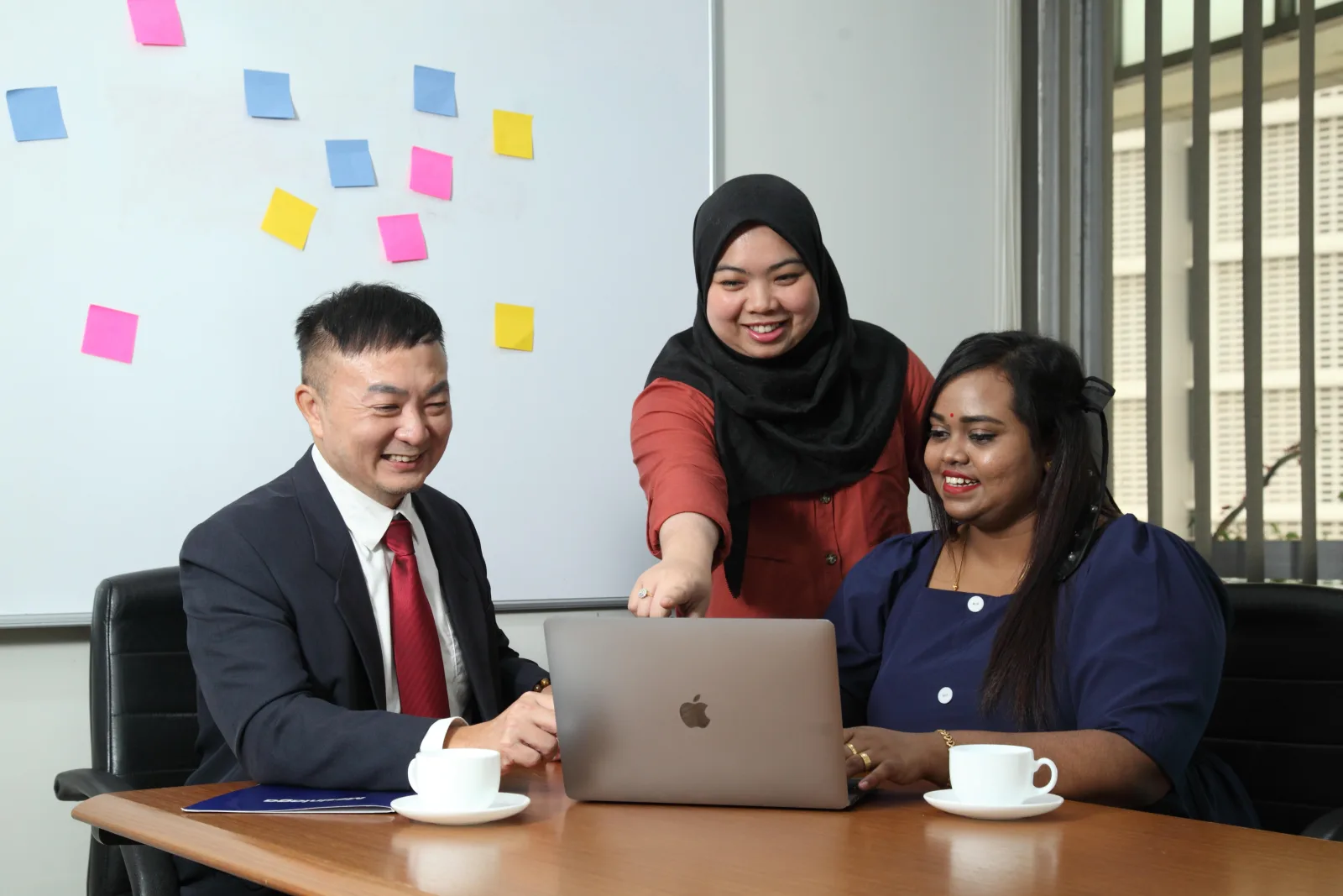 Mesiniaga colleagues collaborating